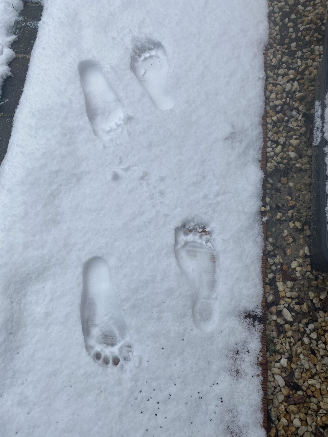 Fußspuren im Schnee vom Barfußlaufen